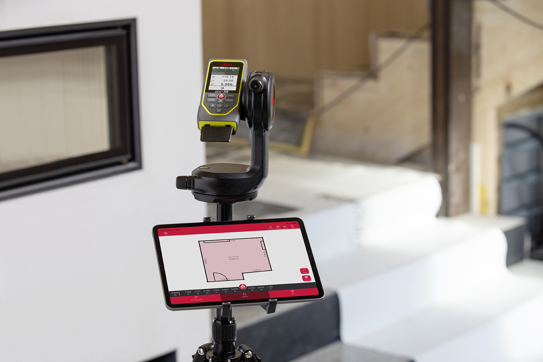 A ground floor is measured with a Leica DISTO X6 laser measure on a DST 360-X tripod adapter and displayed in the Leica DISTO Plan app on a tablet.