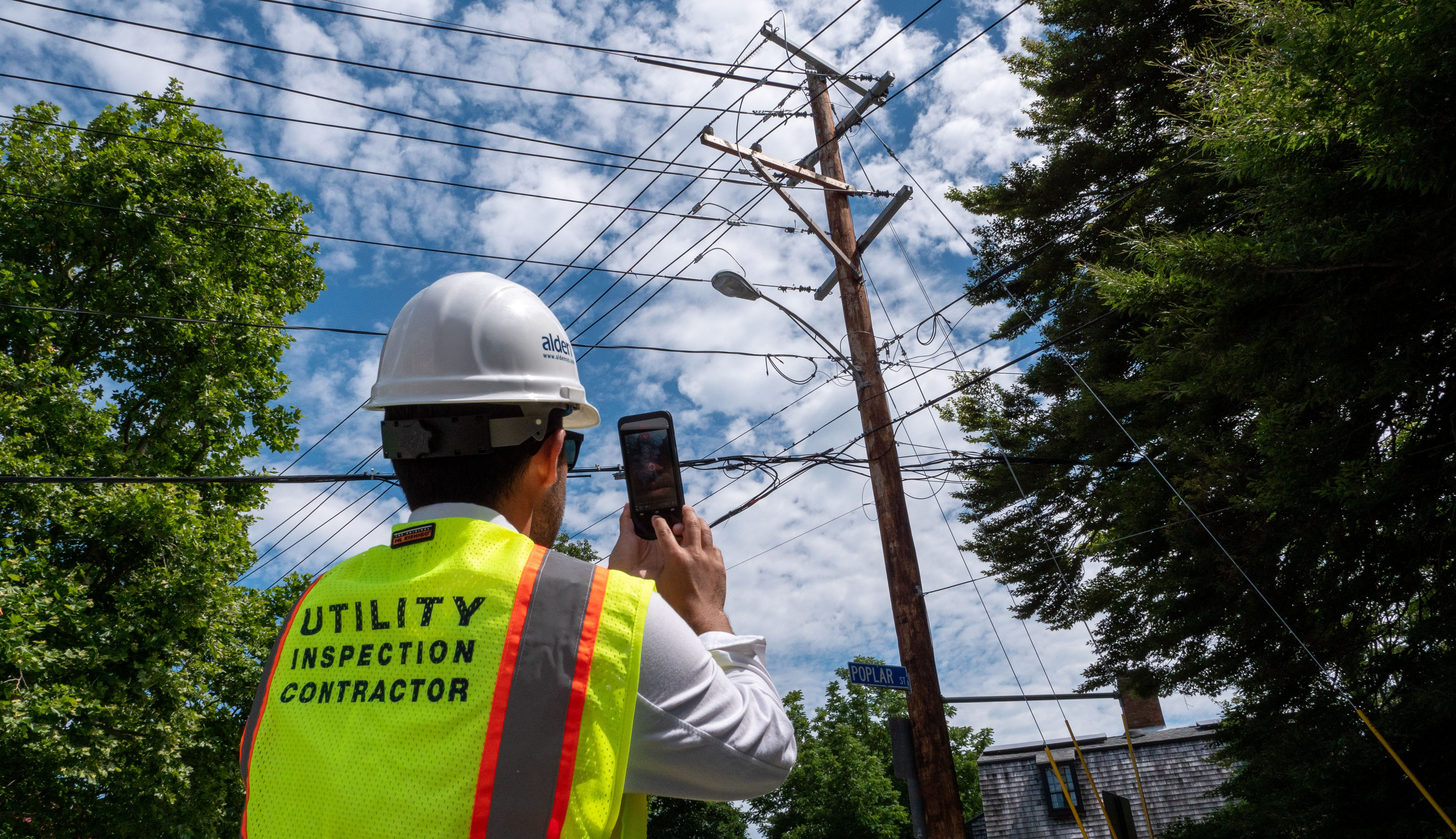 worker measuring utility pole with the BLK3D